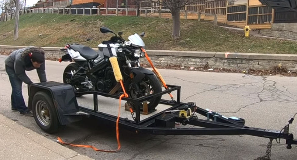 Motorcycle being towed with a White Truck